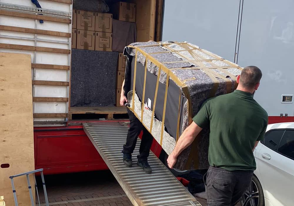 Packing sofa onto van
